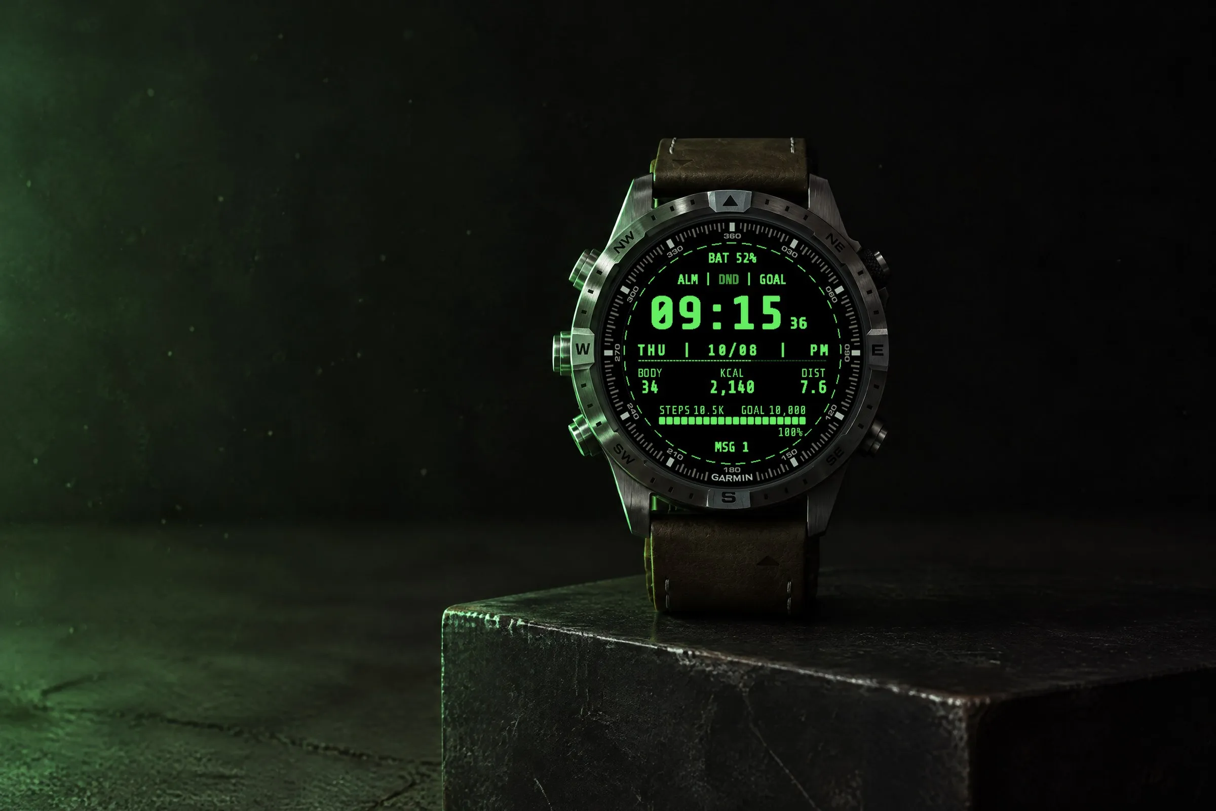 Garmin MARQ with the retro Garmin watch face Terminal in green on a black steel block