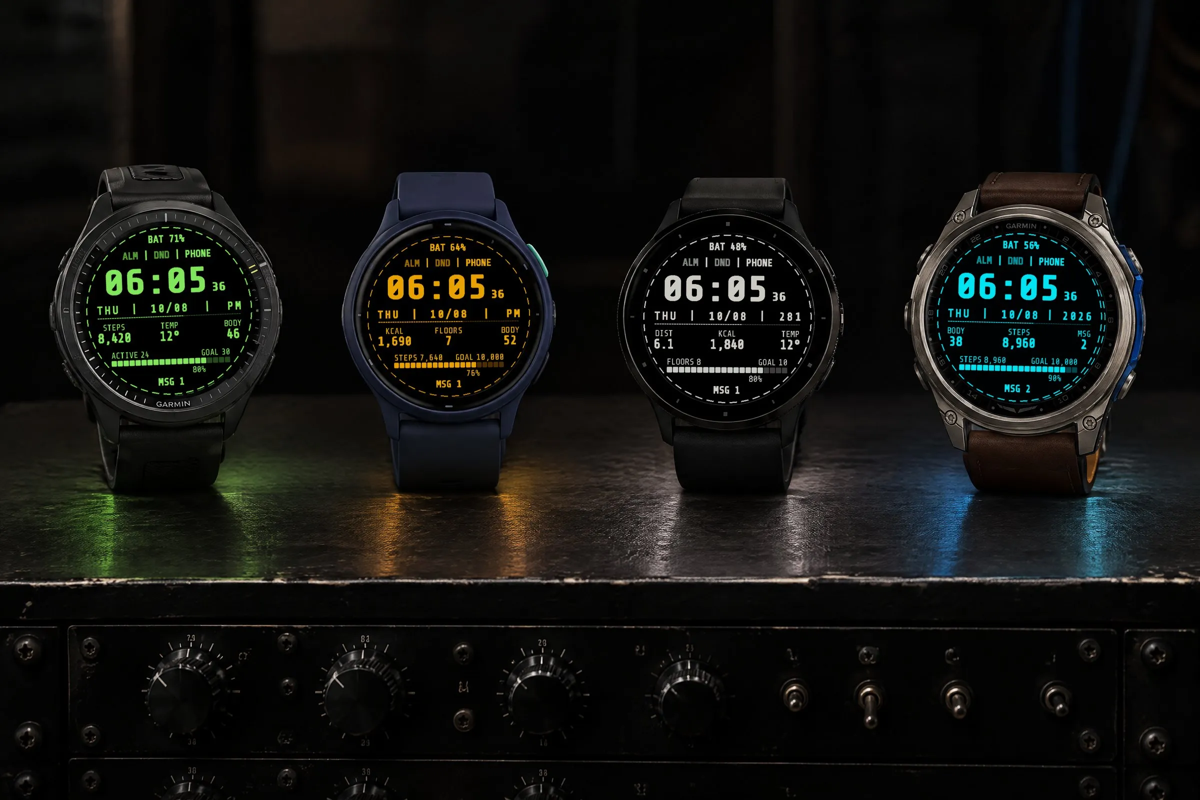 Four Garmin watches with the retro Terminal watch face in green, amber, paper white and cyan on a studio rack